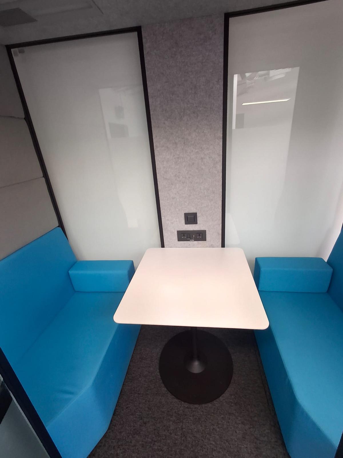 Clean office meeting booth with table and seating
